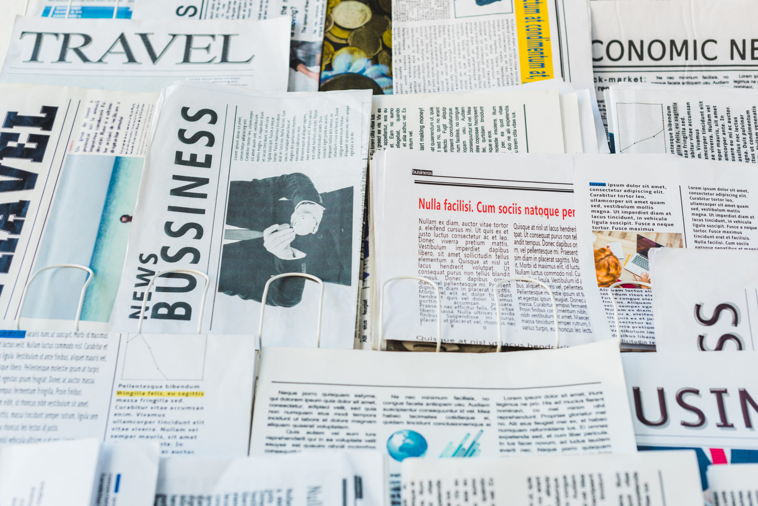 different print daily business and travel newspapers on stand